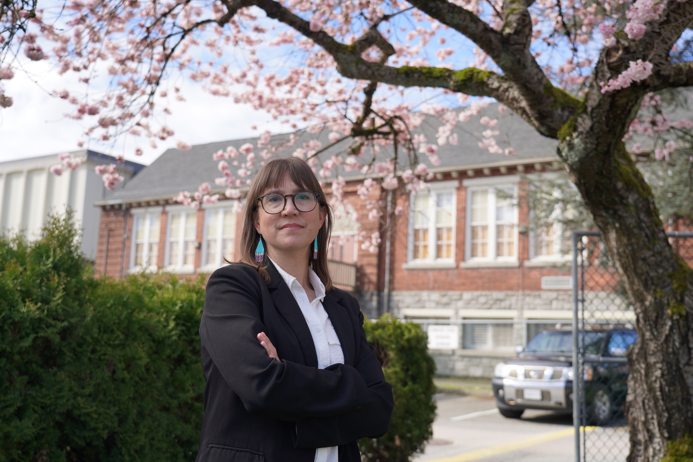 Krista Sigurdson headshot in front of Vancouver Cherry Blossoms