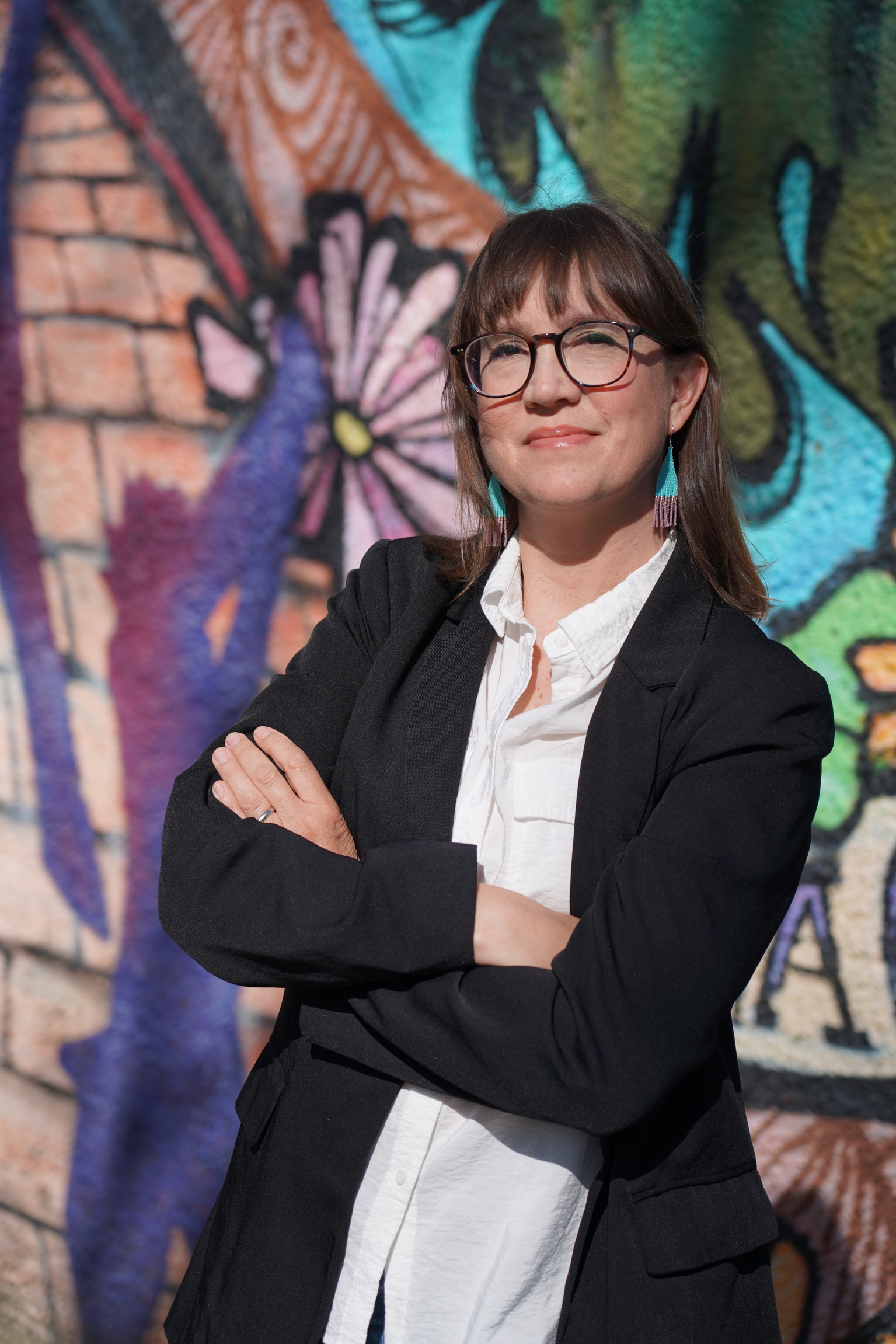Krista Sigurdson headshot in front of Mural